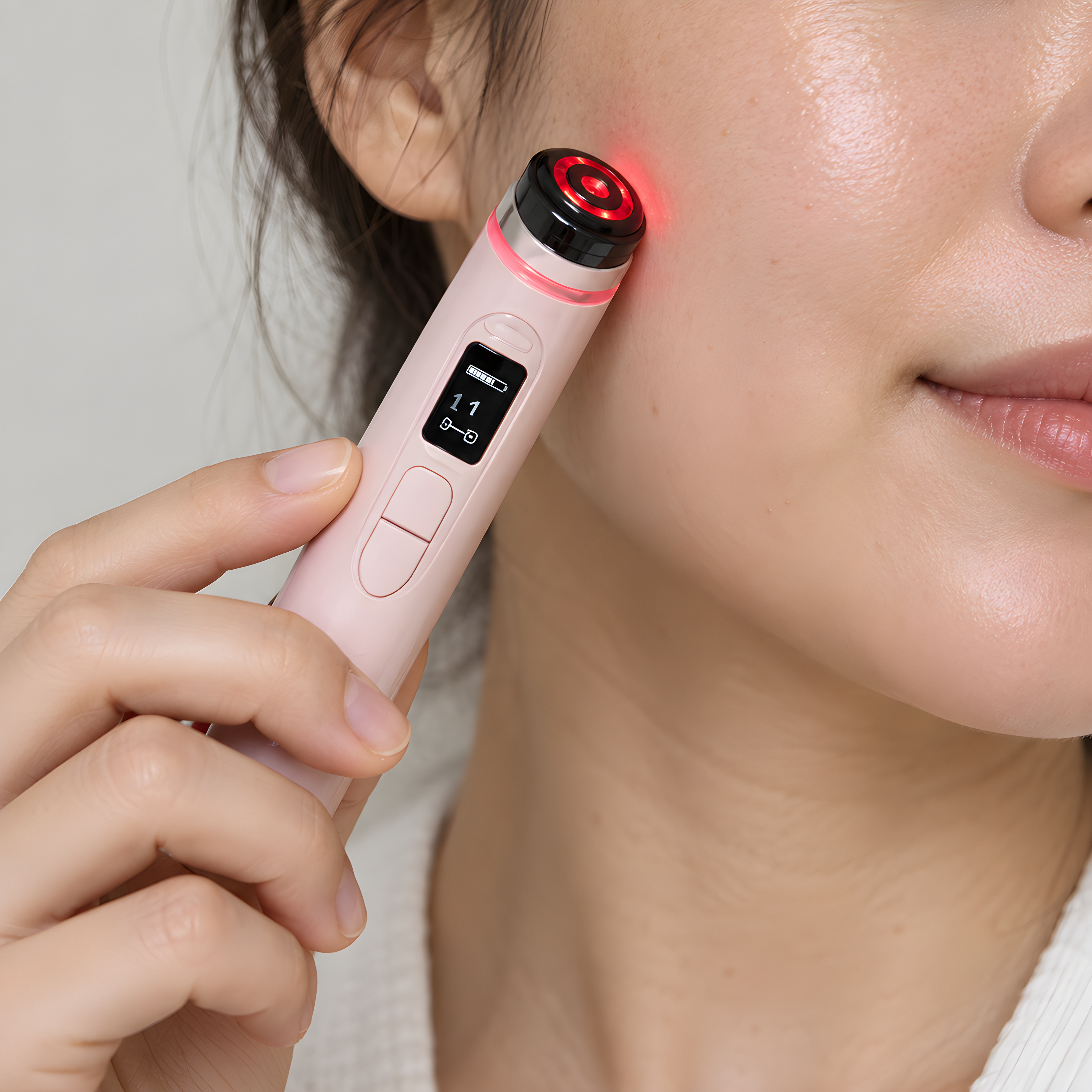 Use the uploaded product image as the exact visual reference for the device. Create a realistic lifestyle product photograph showing a person using this exact facial massager correctly on the cheek area of the face. The device must remain visually identical to the reference image: same shape, proportions, pale pink body, black and red circular head, screen, buttons, and overall design. Do not redesign, modify, add, remove, or invent any part of the product.
Keep the composition very simple and natural. Show only part of the person's face, preferably a close-up of the cheek, jawline and a small portion of the nose, so the person's full face is not visible. One hand naturally holds the device and gently places the circular head against the cheek, clearly demonstrating how the product is used. The device should be clearly visible and remain the main focus.
Make it look like an authentic photograph taken with a modern smartphone or professional lifestyle camera, with realistic human skin texture, natural skin pores, subtle imperfections, realistic hand anatomy and natural fingers. Avoid the artificial appearance commonly associated with AI-generated people. Soft natural lighting, clean neutral background, minimal composition, realistic shadows, no excessive beauty retouching.
No text, no logos, no graphic elements, no arrows, no icons, no additional products, no futuristic effects, no exaggerated smile, no studio-model pose, no full face, no distorted hands, no extra fingers. The image should simply communicate: “this is how you use the facial massager.” Photorealistic, clean, natural, simple and commercially suitable for an online store.
La clave es que el generador entienda que no debe crear un producto parecido, sino reutilizar exactamente el que aparece en tu referencia. También le estamos dando una composición donde la cara no tiene que verse completa, lo que reduce muchísimo el riesgo de que la persona parezca artificial.